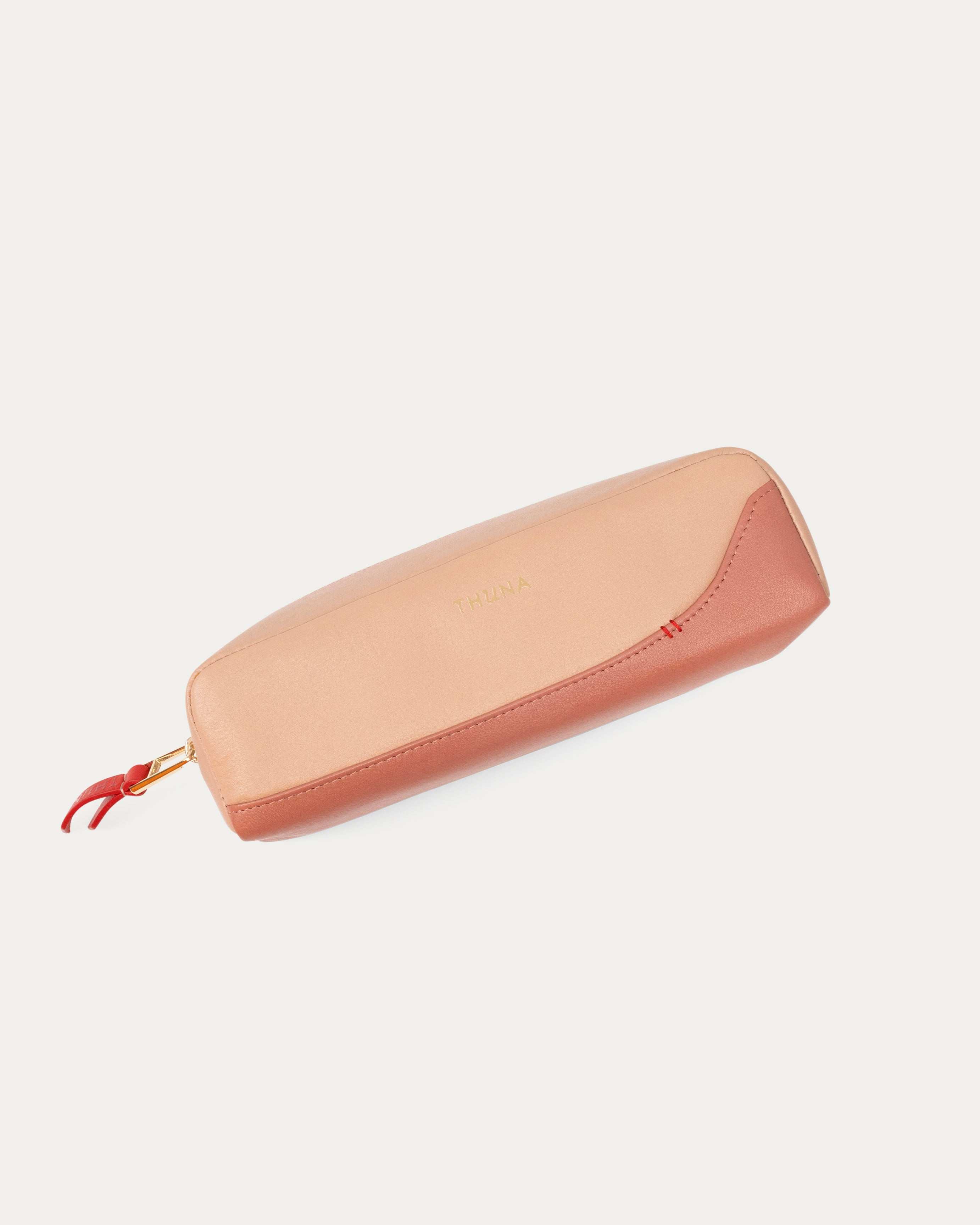 Two-tone beige and pink pouch with a red zipper on a white background - Kuwait BAGS - KSA bags